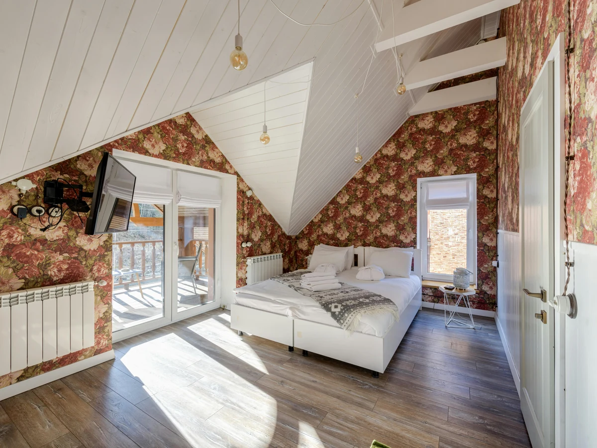 Attic bedroom with bold feature wall painting in Coventry