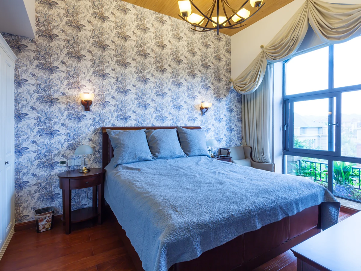 Bedroom with blue botanical feature wall in Coventry