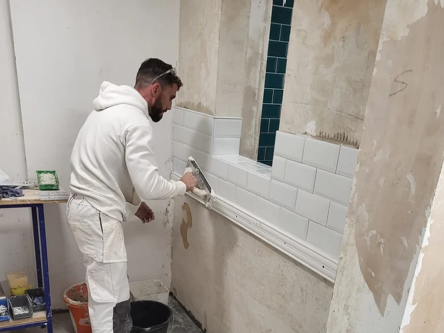 Decorator at work during an out-of-hours office job in Coventry
