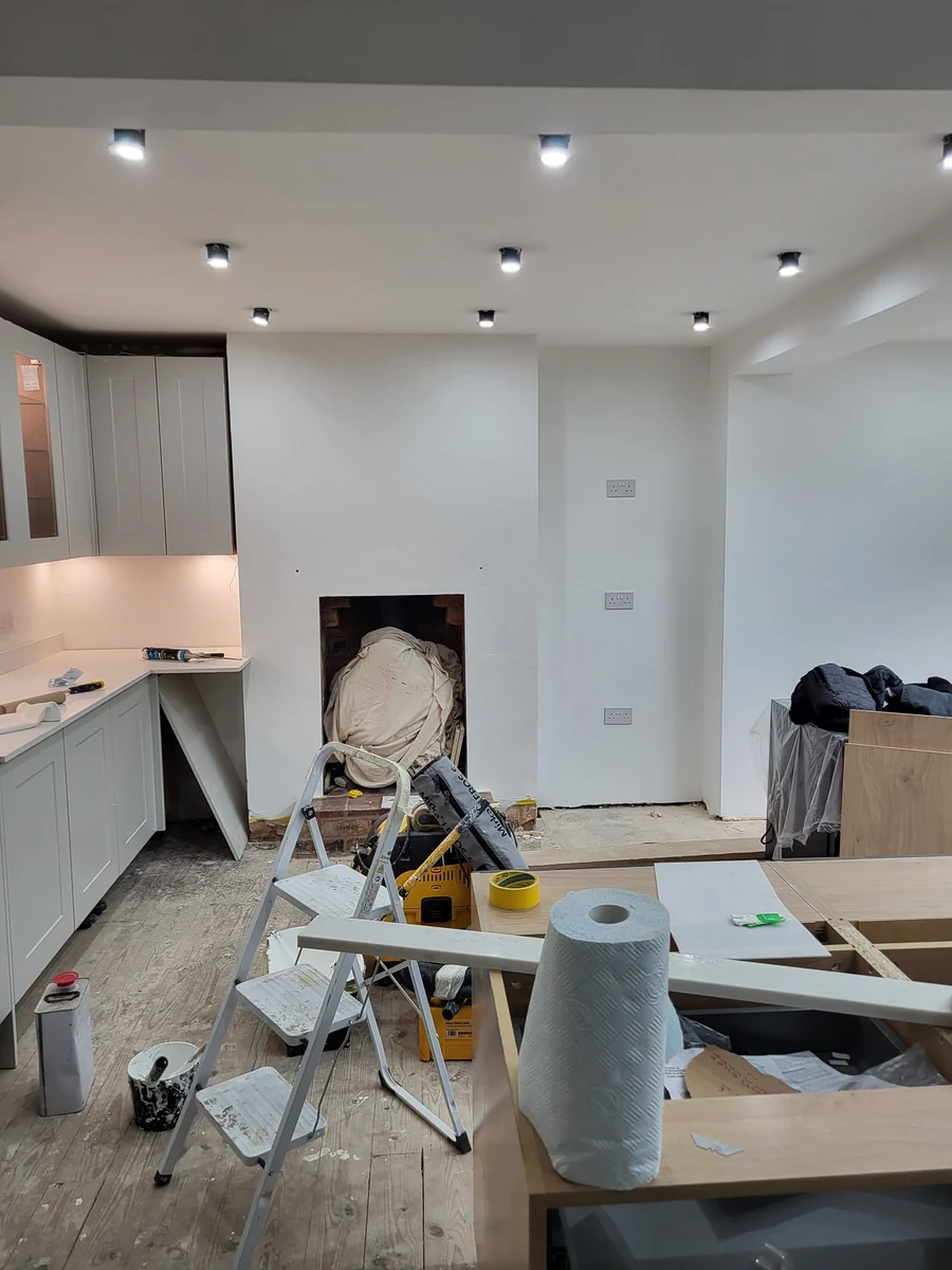Room under dust sheets during preparation on an empty house decorating job in Coventry