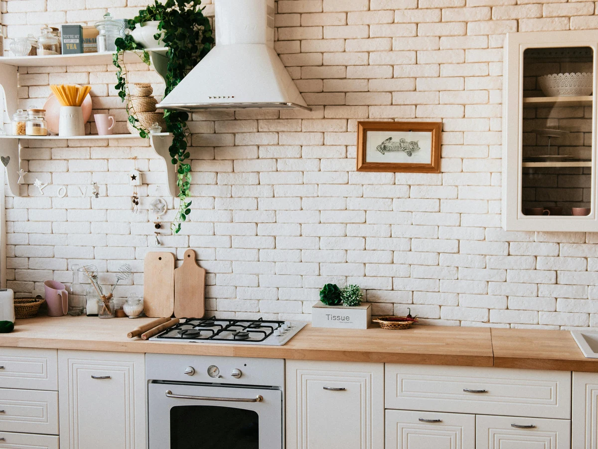 Rustic white kitchen with painted cabinets by Godiva Decorators