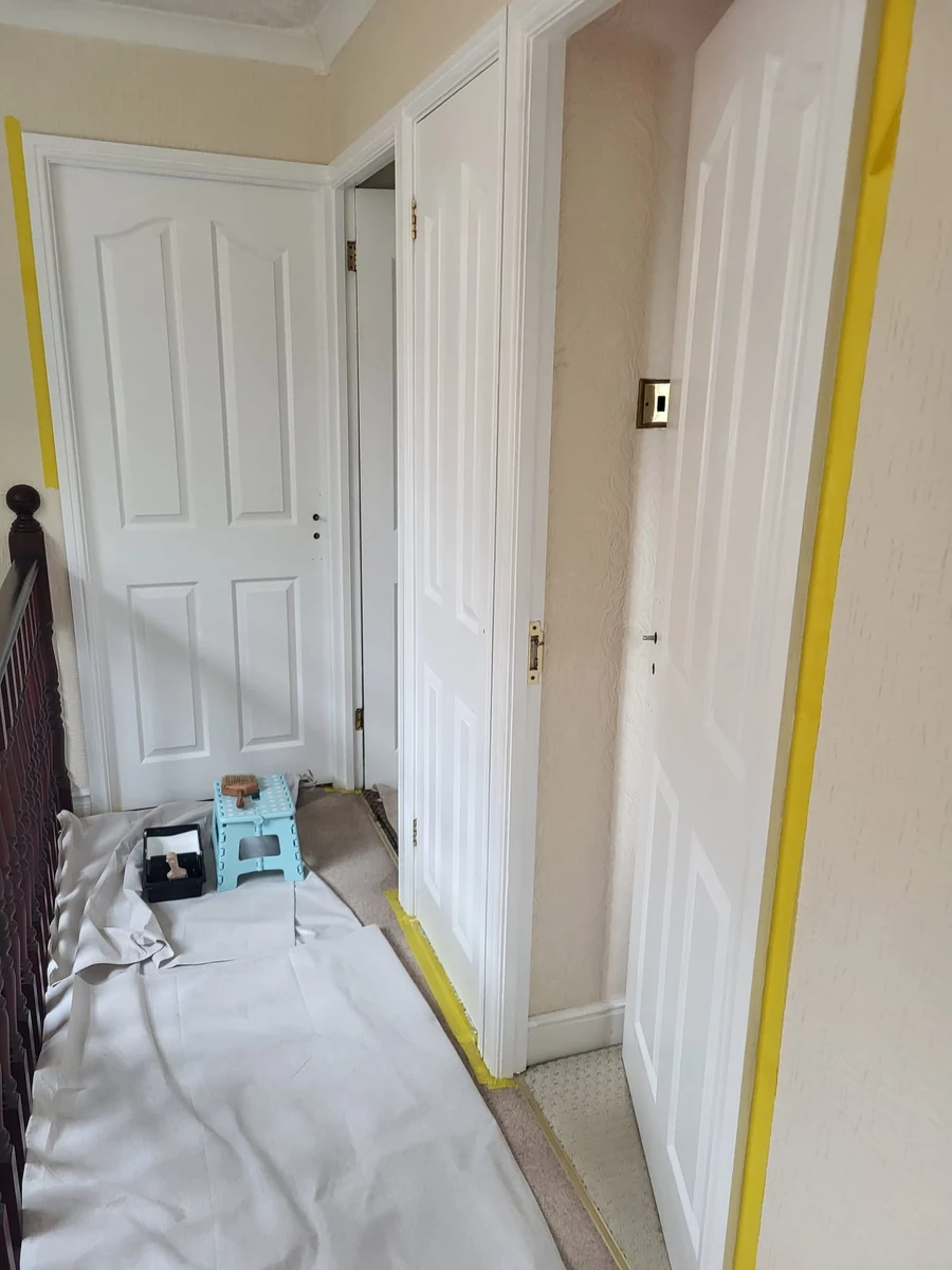 Masked door frame and filled woodwork ready for painting