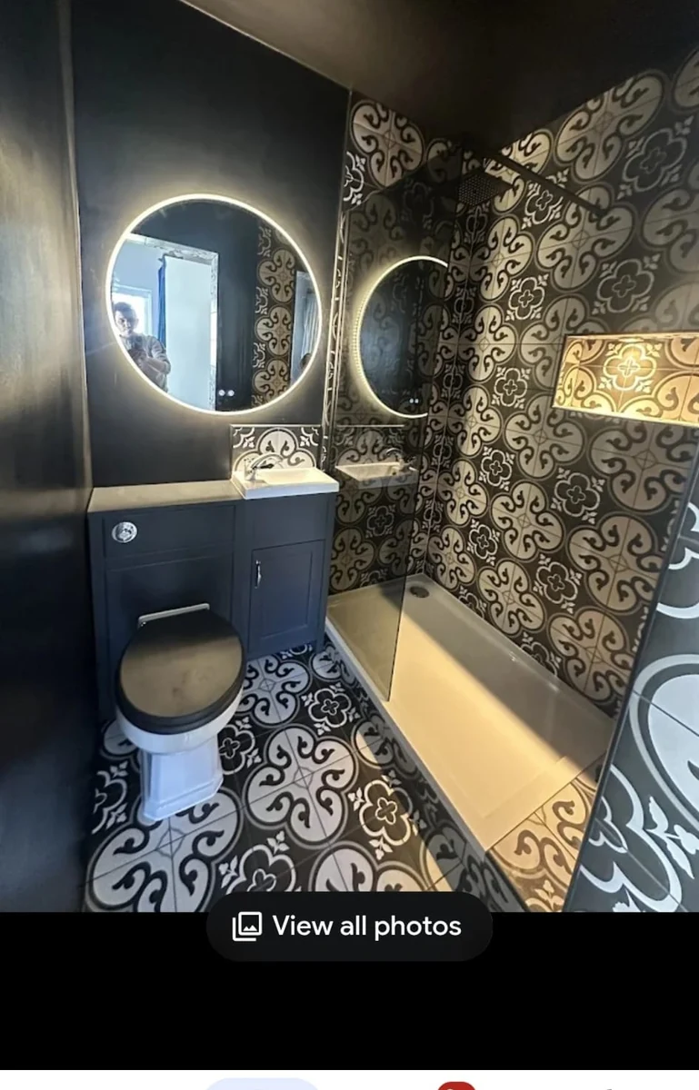 patterned-feature-bathroom-coventry-godiva-decorators Bathroom with patterned feature tiling and round mirrors in Coventry by Godiva Decorators (completed)