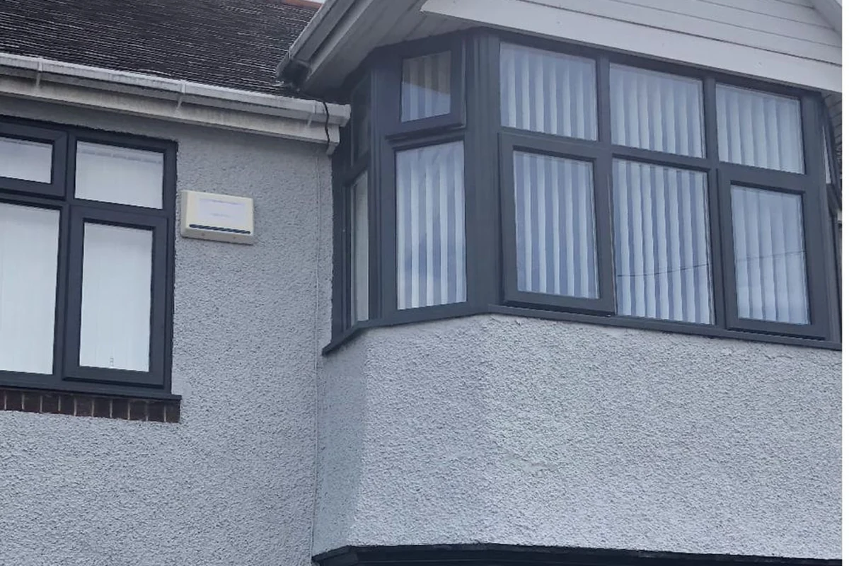 render-painting-coventry-godiva-decorators Rendered bay-fronted house with dark grey windows after repainting, Coventry