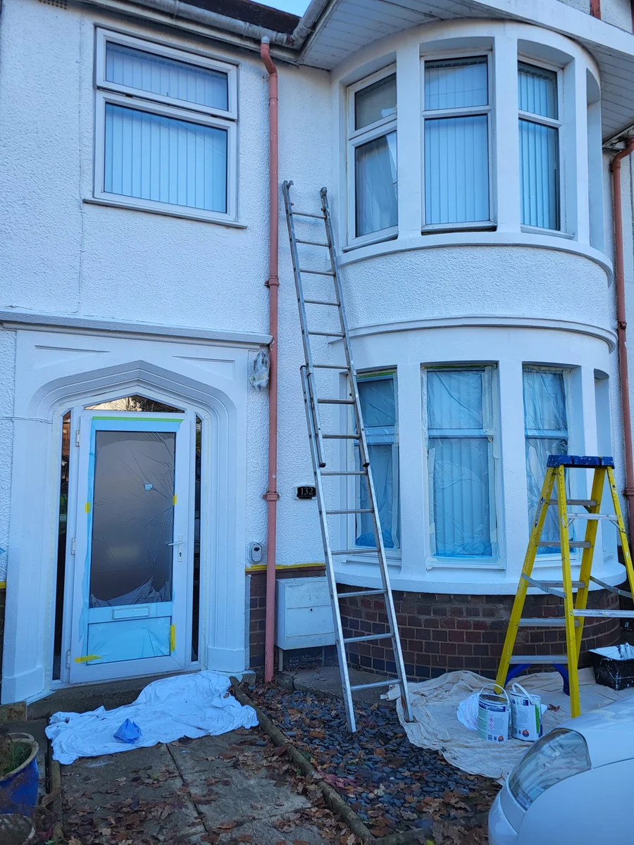 Exterior repaint in progress with access scaffold to a bay-fronted house in Coventry by Godiva Decorators (in progress)