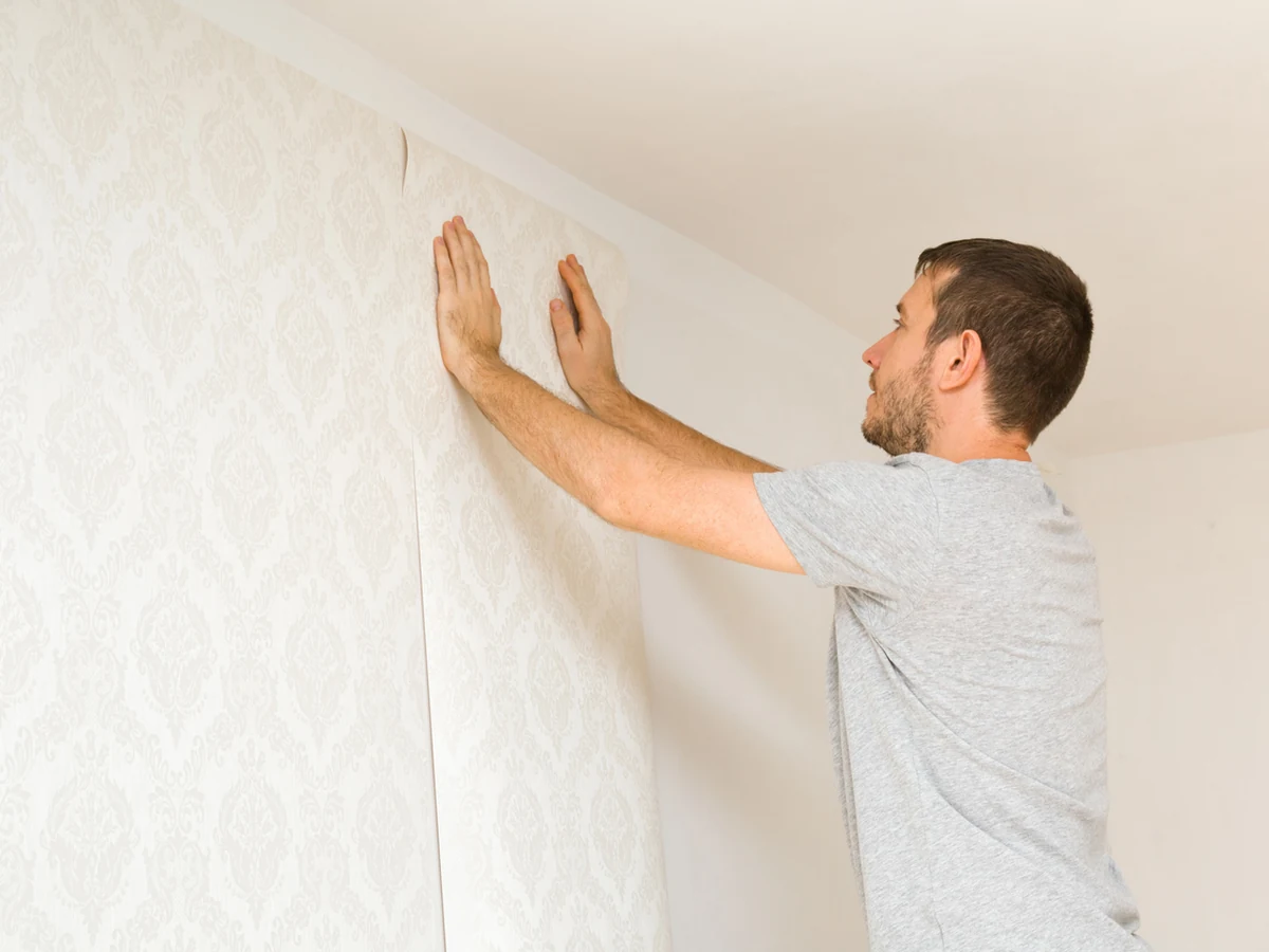 wallpapering-man-pressing-patterned-godiva-decorators Professional wallpapering service in Ryton-on-Dunsmore